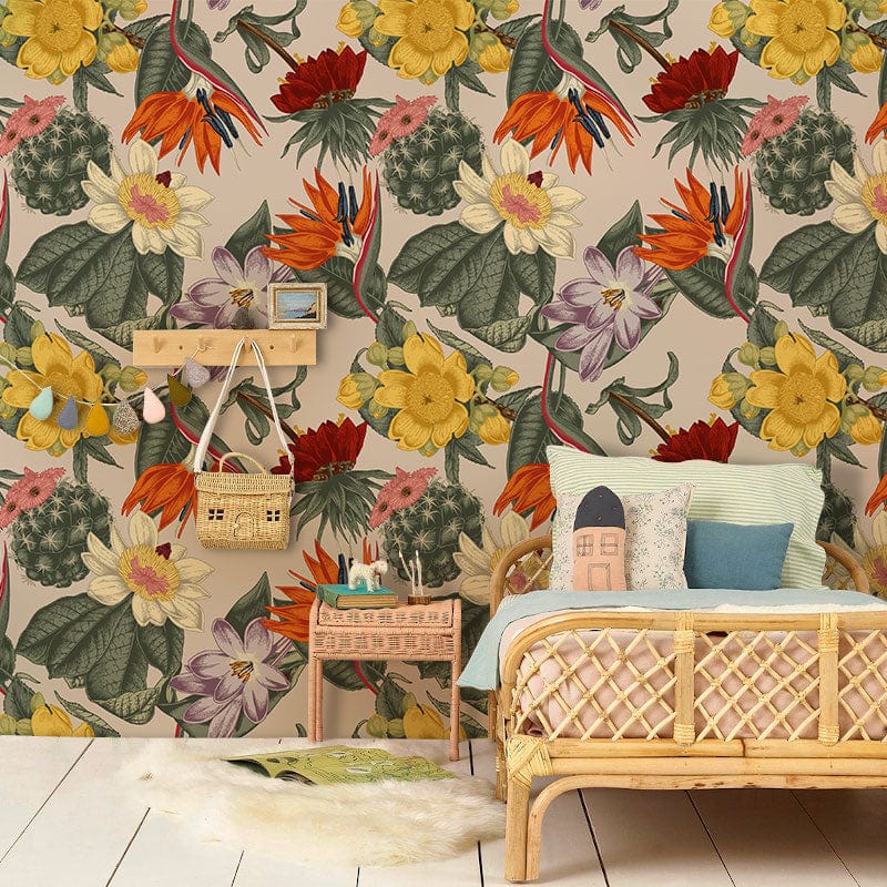 Vintage floral wallpaper with colourful blossoms, pale wood floor, woven bed, pastel cushions, children's room.