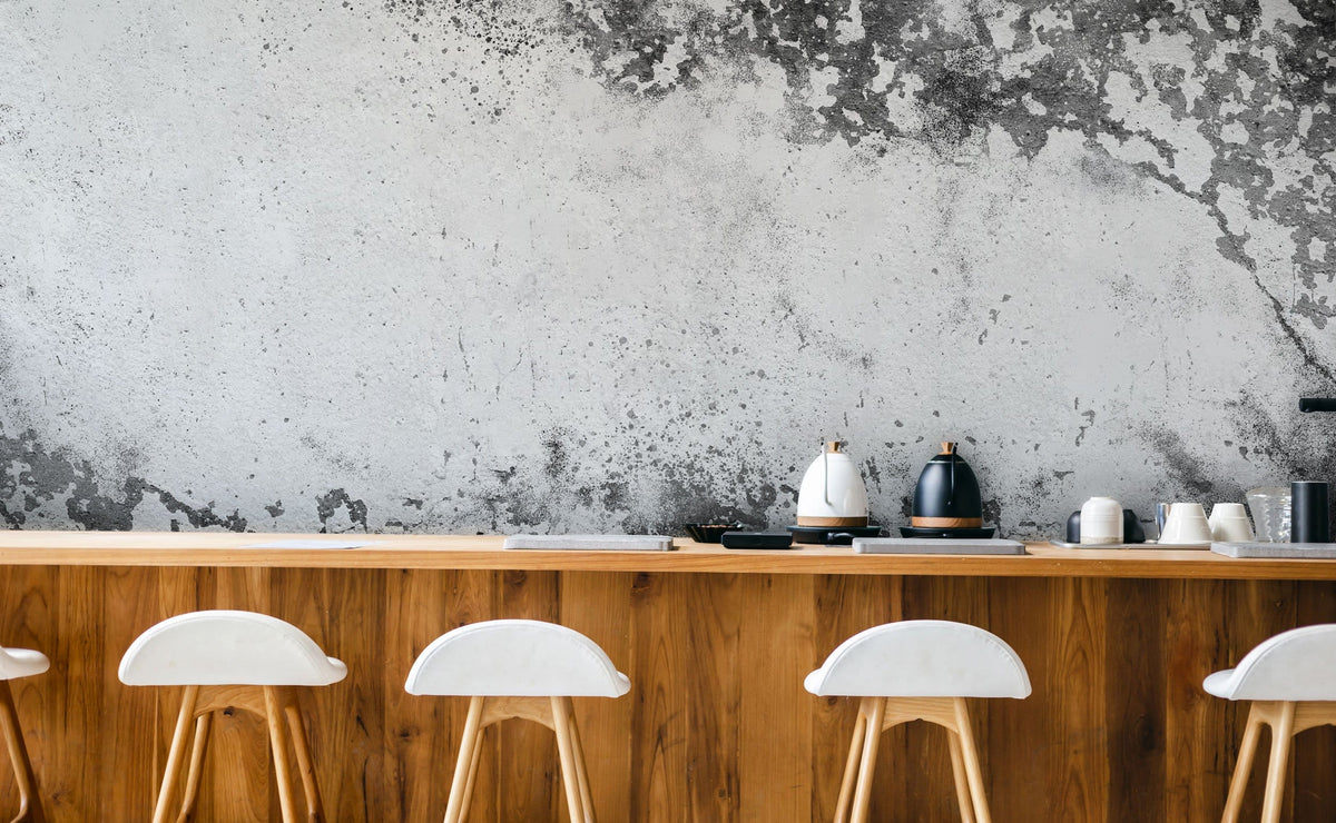 Antique grey industrial chic mural wallpaper, modern wood bar counter, white stools, minimalist kitchen interior.
