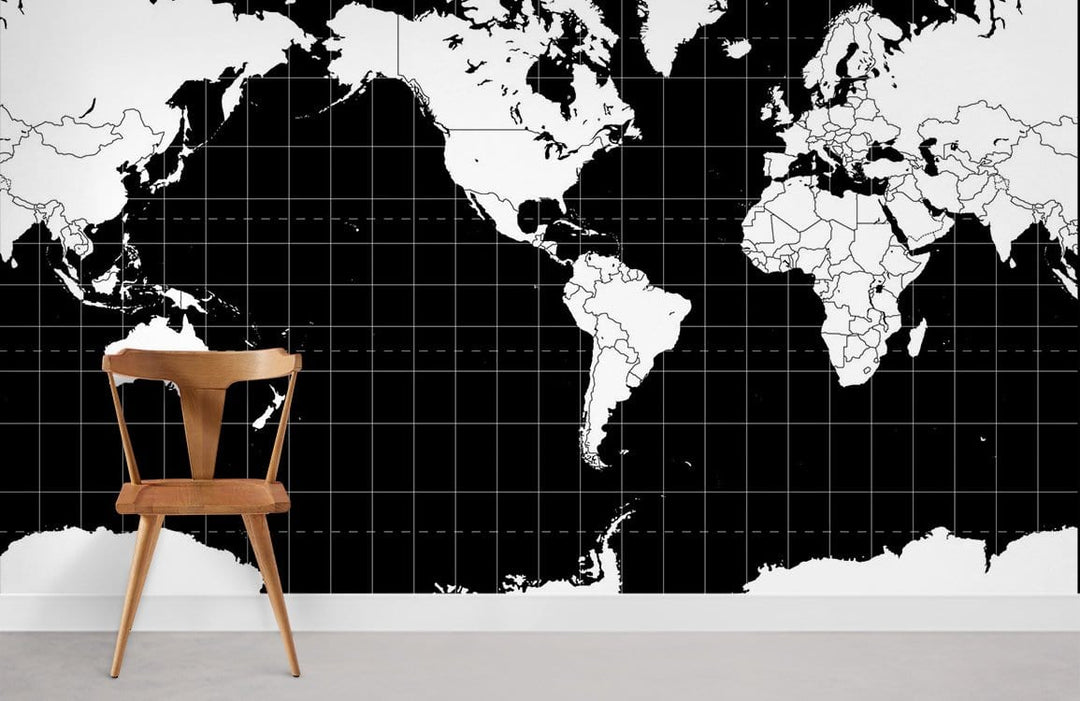 Monochrome World Map Mural Wallpaper in chic black and white, featuring wooden chair, minimalist style.