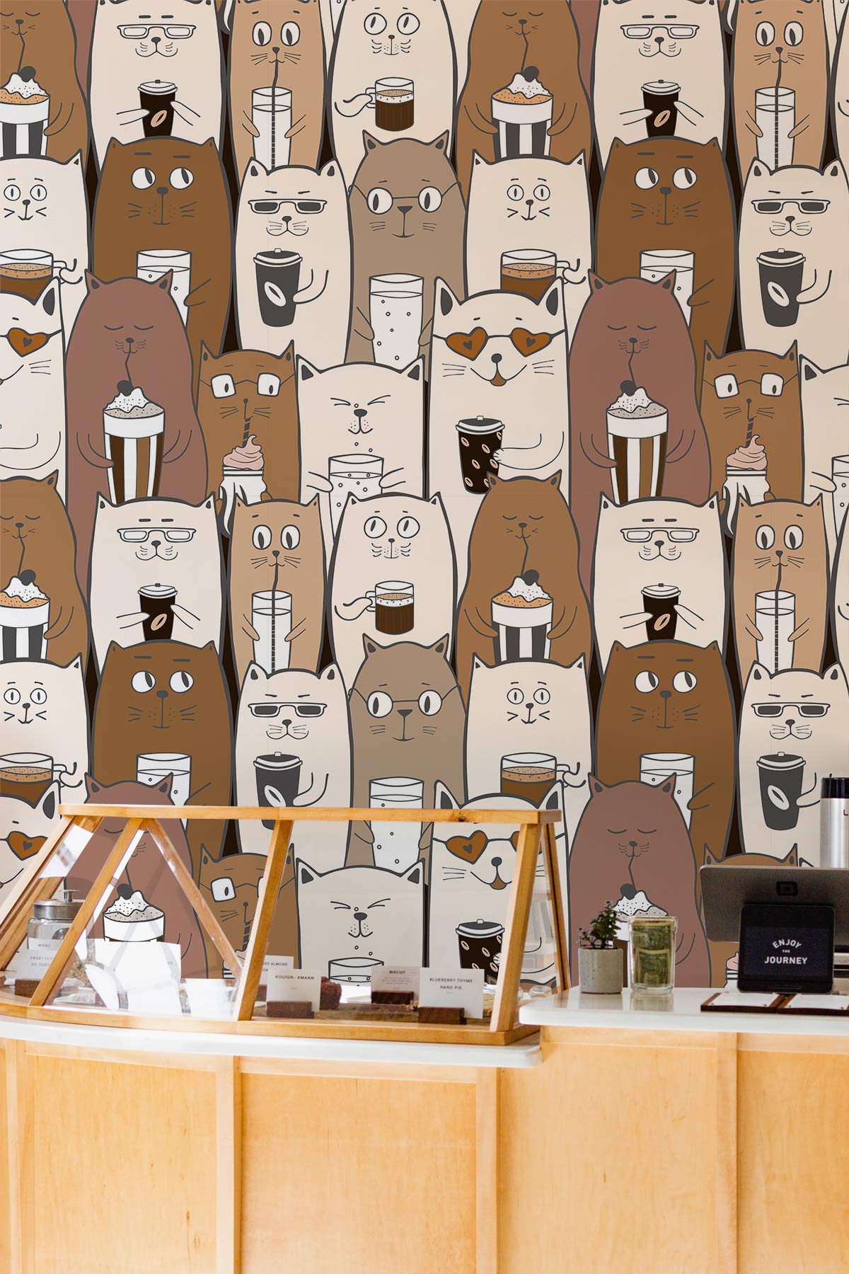 Whimsical Coffee Cats wallpaper; quirky brown, beige pattern; wooden counter transforms playful cafe space.