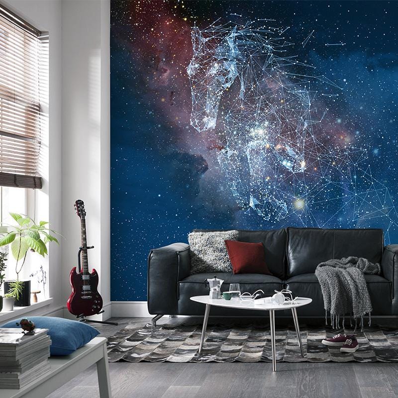 Galactic Constellation Night Sky mural with cosmic blue tones in modern living room with dark sofa.