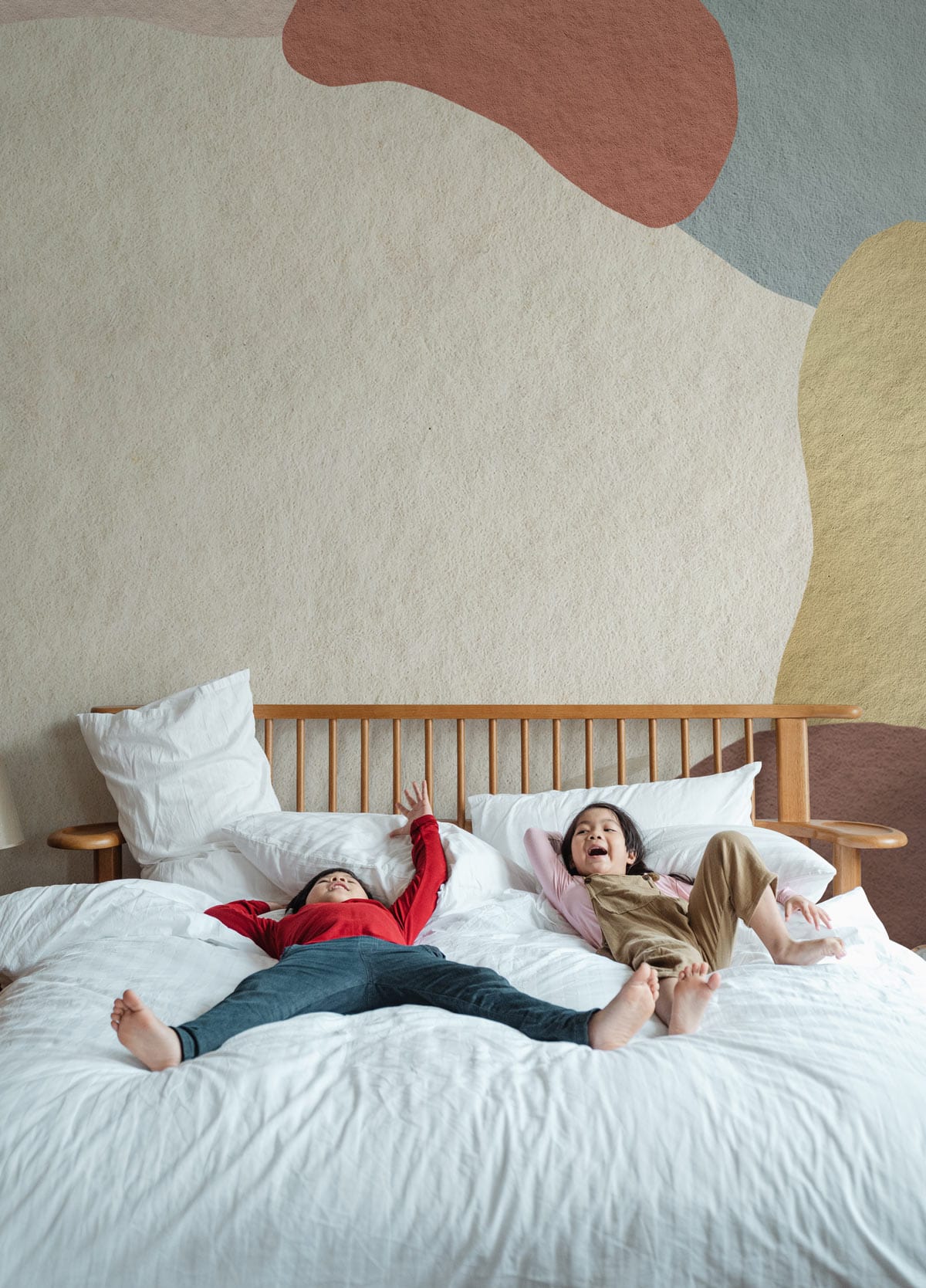 Abstract pastel wallpaper in modern bedroom, wood bed, white bedding, organic pattern design.