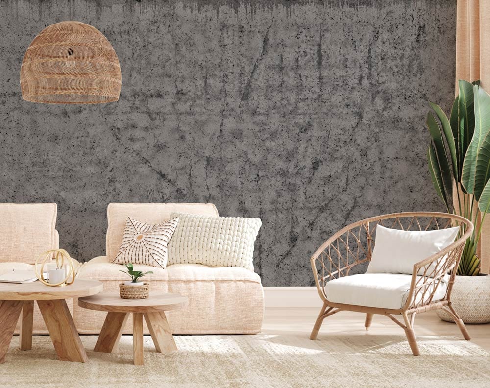 Industrial grey concrete effect wallpaper for modern decor; beige sofas, rattan chair, light wood flooring.