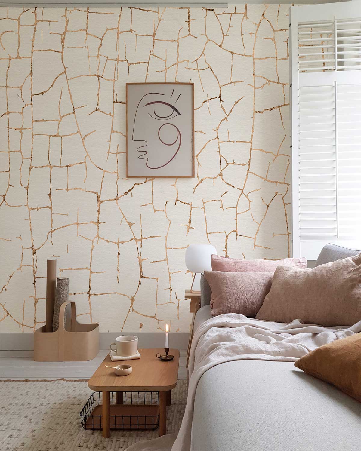 Cracked vintage white textured wallpaper in living room with modern sofa, wooden table, and abstract artwork.