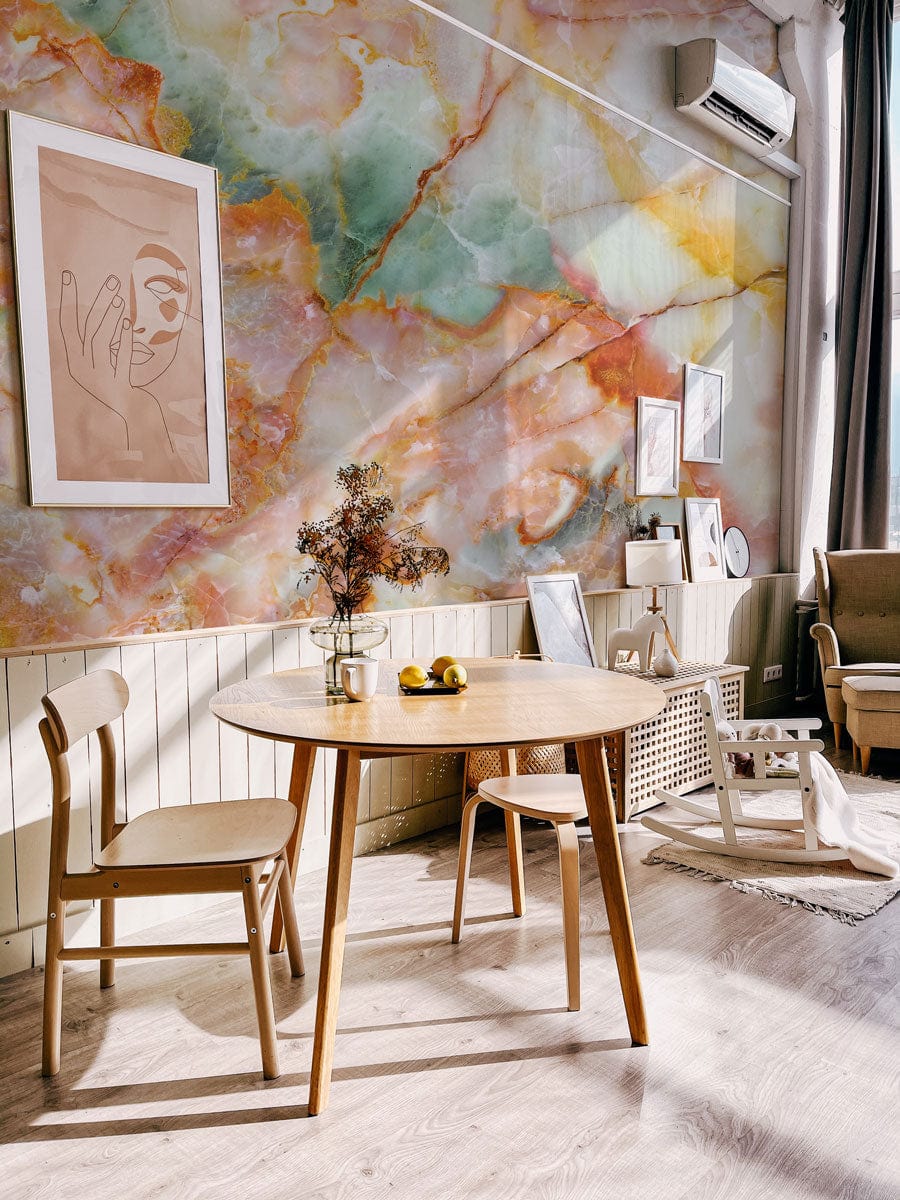 Colourful Marble Effect Wallpaper enhances dining area with wooden furniture, abstract art, and light flooring.