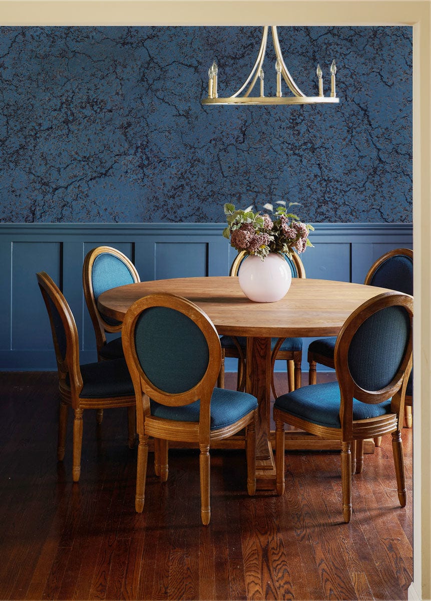 Midnight Blue Crackle Textured Wallpaper, round wooden table, upholstered chairs, chandelier, wooden flooring.