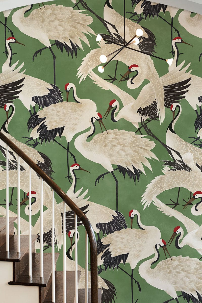 Elegant green crane wallpaper in hallway with wooden staircase, contemporary chandelier, Oriental Décor.