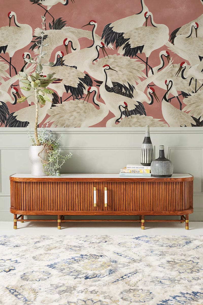 Elegant Coral Crane Pattern Wallpaper, wooden cabinet, Japanese-themed decor, ornate rug, muted wall.