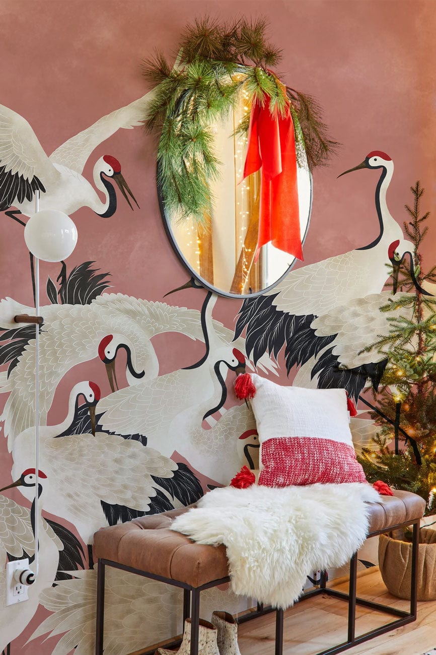 Elegant coral crane wallpaper in cosy room with brown bench, white cushion, and decorative mirror.