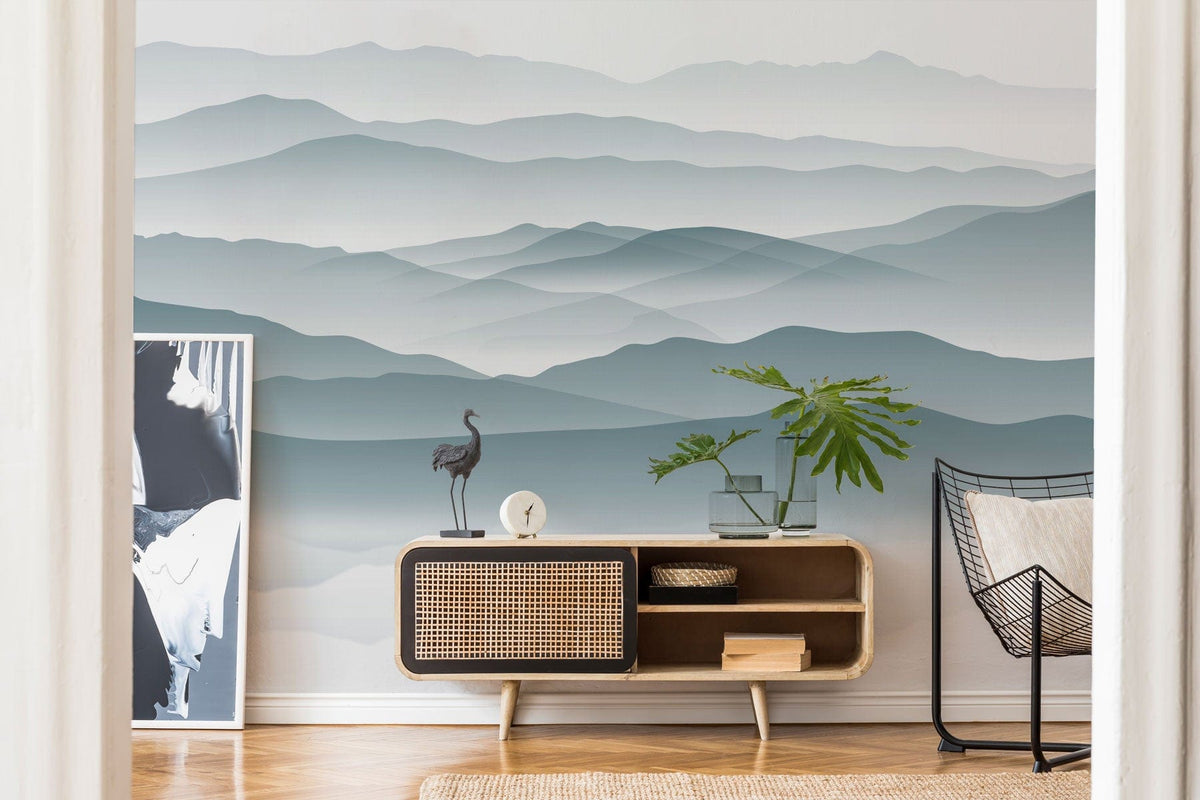 Serene Misty Mountains mural in living room with wooden console, artwork, decorative items, and chair.