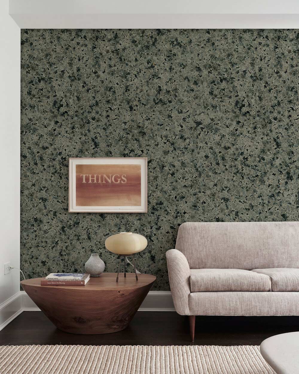 Elegant grey granite textured wallpaper with beige sofa and wooden coffee table in modern living room.