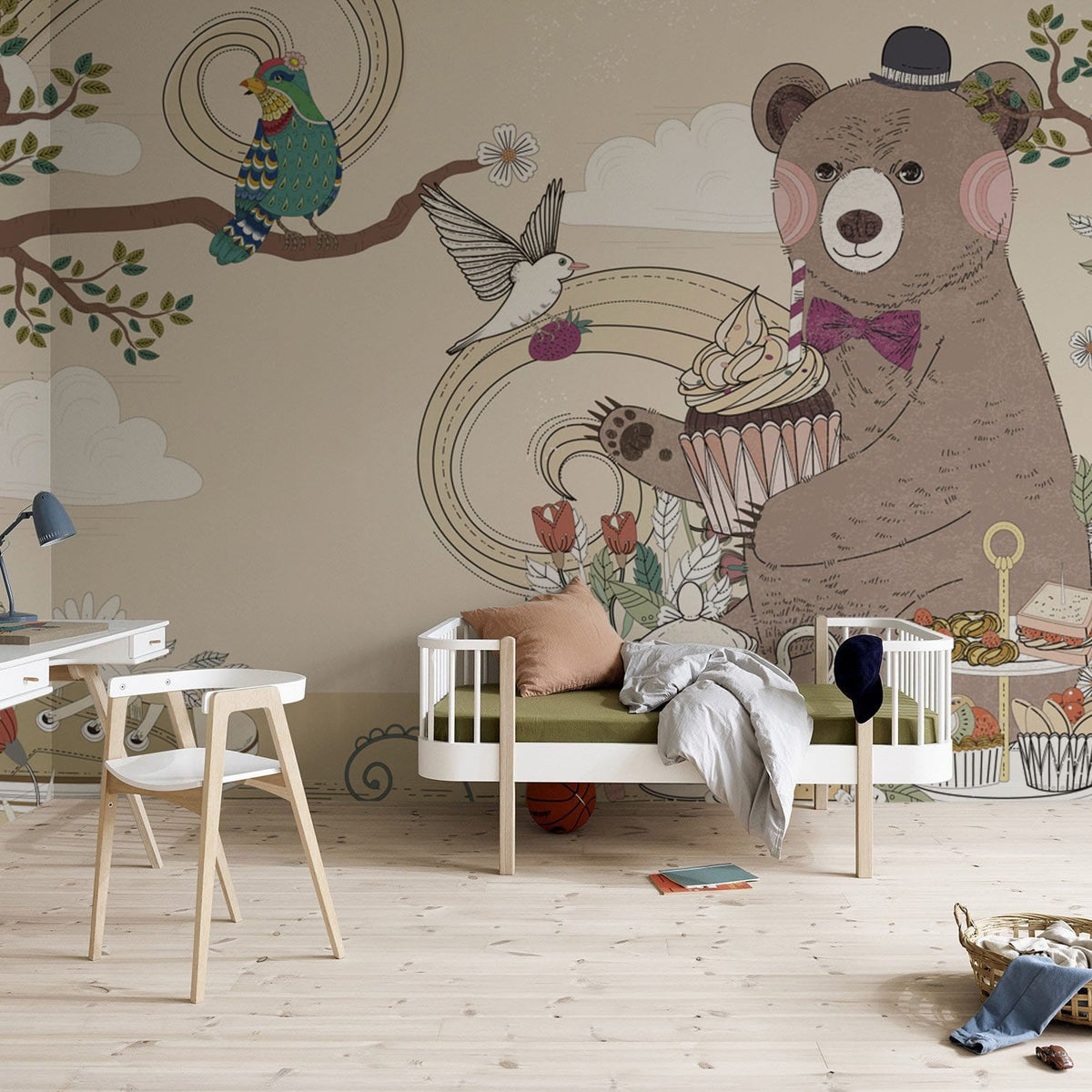 Whimsical woodland mural wallpaper with playful bears, birds; featuring pastel tones, light wood flooring, children's room.