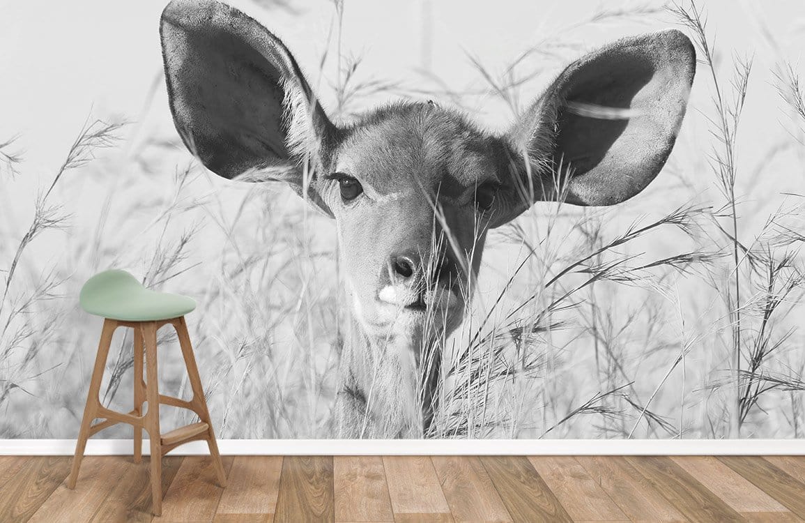 Monochrome Safari Serenity wildlife mural in minimalist room, wooden flooring, and modern stool.