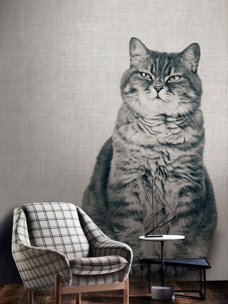 Plaid armchair and cat wallpaper, sepia tone, adds classic British charm to living room decor.