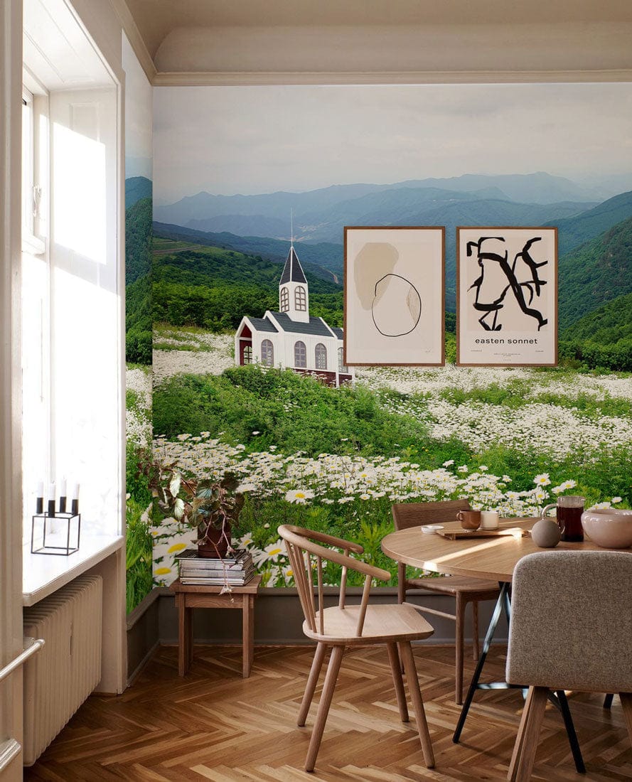 Charming countryside church mural wallpaper in dining room with wooden floor and elegant wooden chairs.