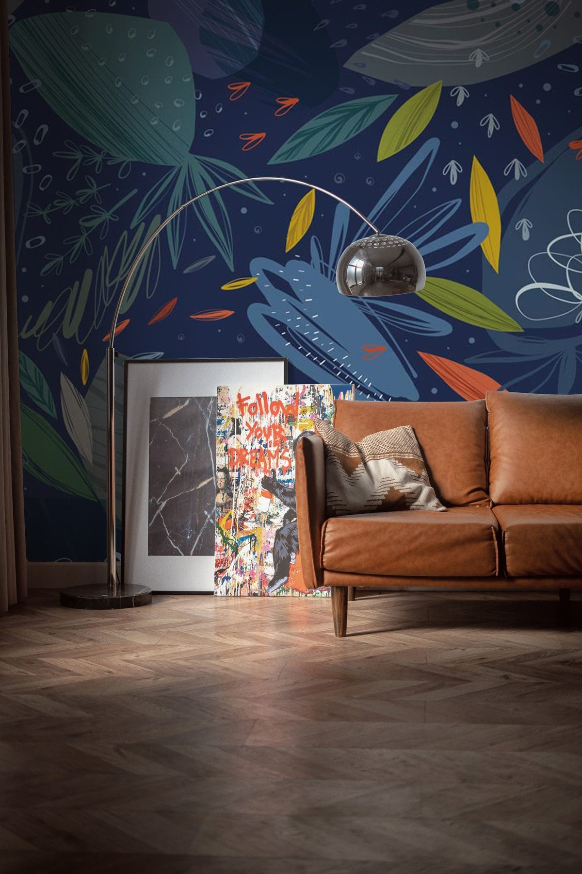 Midnight Botanical Dreamscape wallpaper, deep blue tones, brown leather sofa, wooden flooring, modern lamp.