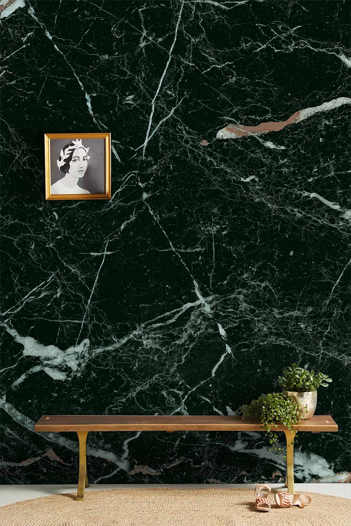 Luxurious black marble wallpaper, elegant white veining, wooden bench, round rug, framed portrait art.