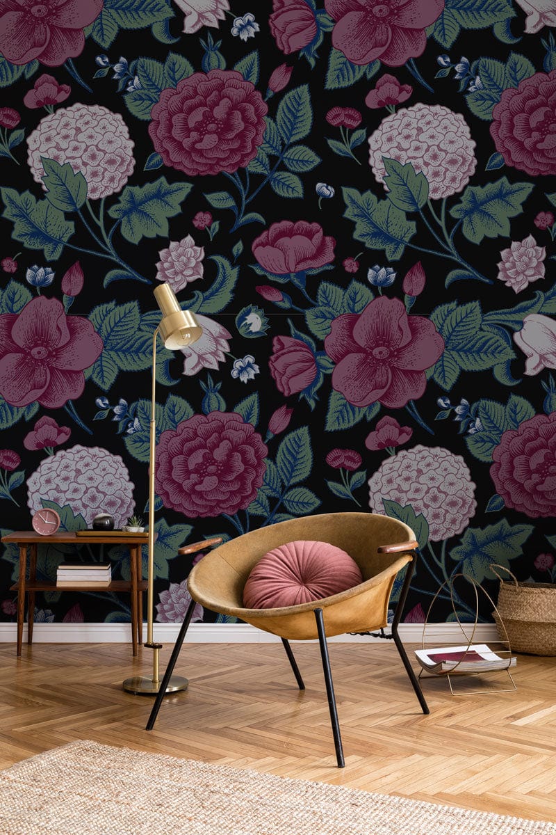Vintage floral wallpaper in black, pink, green with wood flooring, cosy chair, and elegant floor lamp.