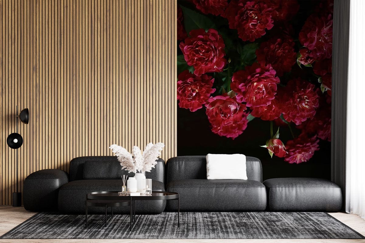 Elegant Crimson Rose Blossom Floral Wallpaper in modern living room with dark sofa, wooden panelled wall.