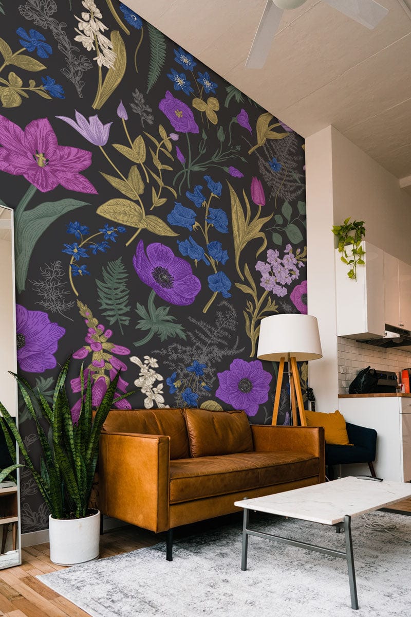 Botanical Bliss Dark Floral Wallpaper enhances living room with tan leather sofa and modern floor lamp.
