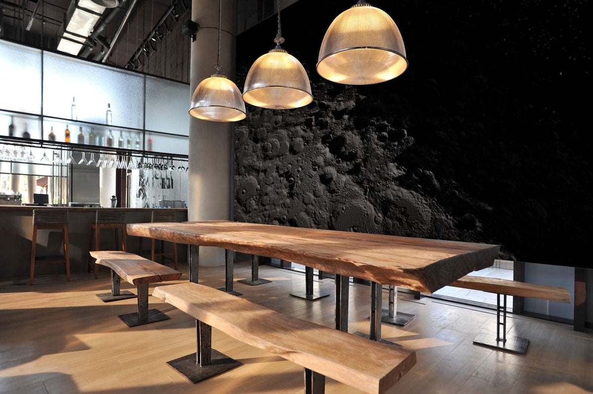 Modern dining room with Moonlit Crater Wallpaper, wooden table, benches, pendant lights, hardwood flooring.