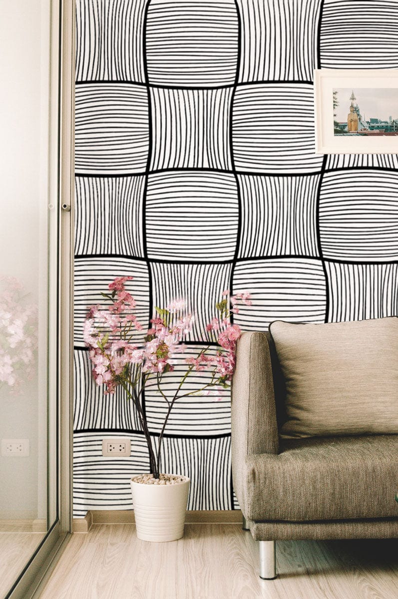 Monochrome geometric wallpaper, brown sofa, beige flooring, modern interior decor with flower decoration.