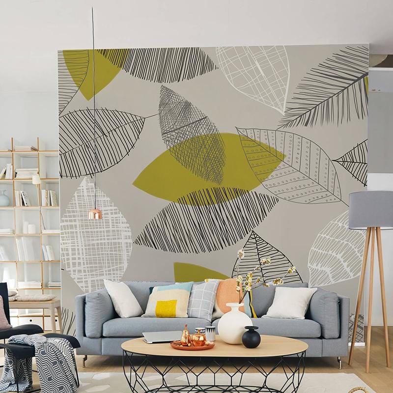 Autumnal Leaf Pattern Beige and Green Wallpaper in living room with grey sofa, wooden flooring, decorative shelves.