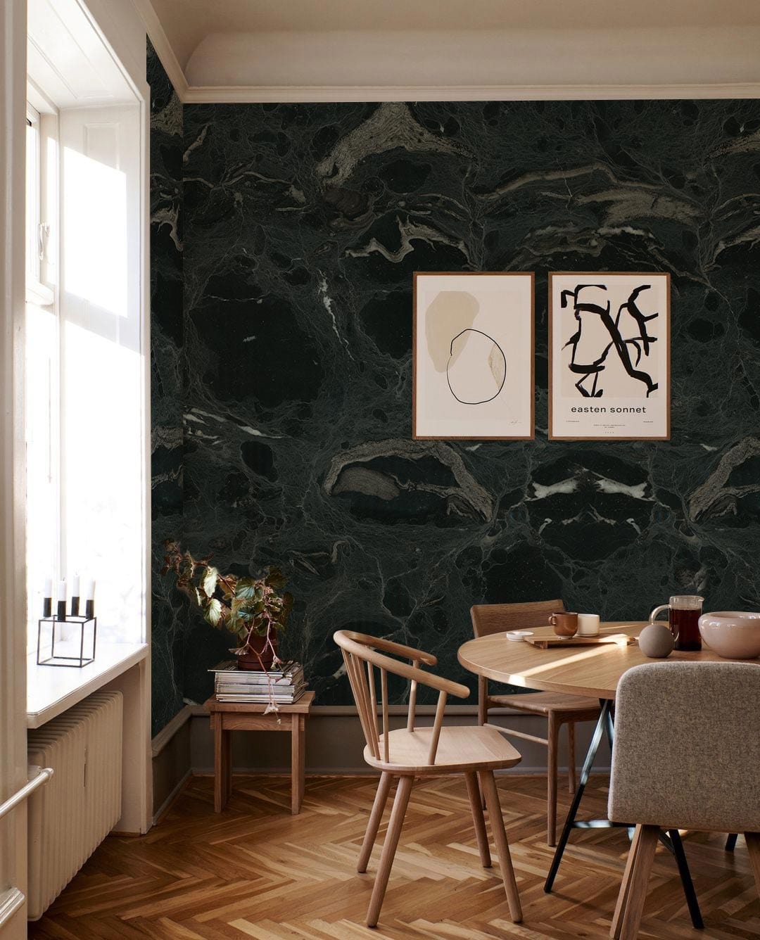 Elegant dark marble wallpaper in modern dining room with wooden flooring, stylish chairs, and wall art.