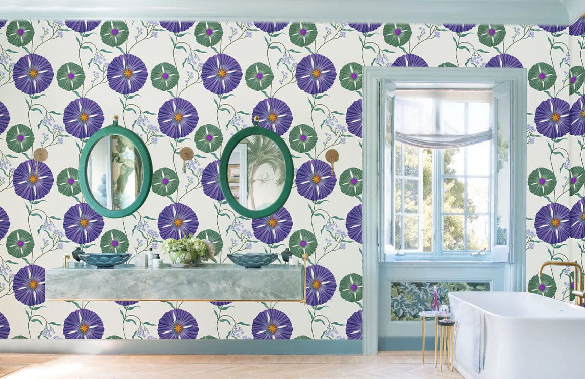 Vintage purple floral wallpaper with green accents in elegant bathroom; marble countertop, mirrors, bathtub.