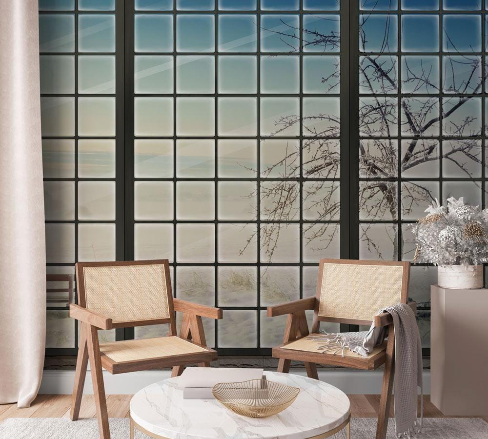 Winter Serenity Frosted Window Mural Wallpaper in a modern living room with wooden chairs and rug.