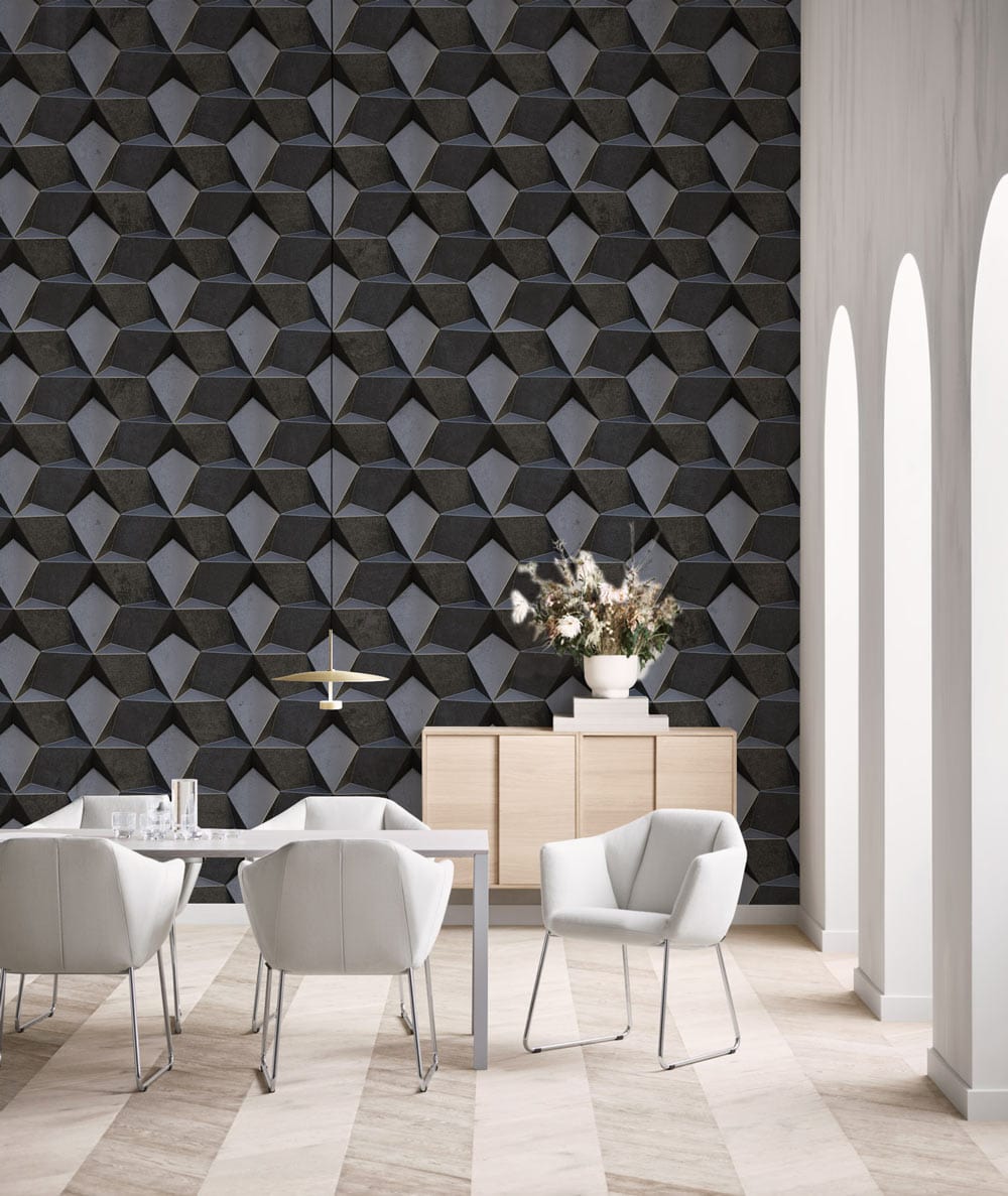 Modern dining room featuring geometric charcoal grey 3D wallpaper with white chairs and chevron flooring.