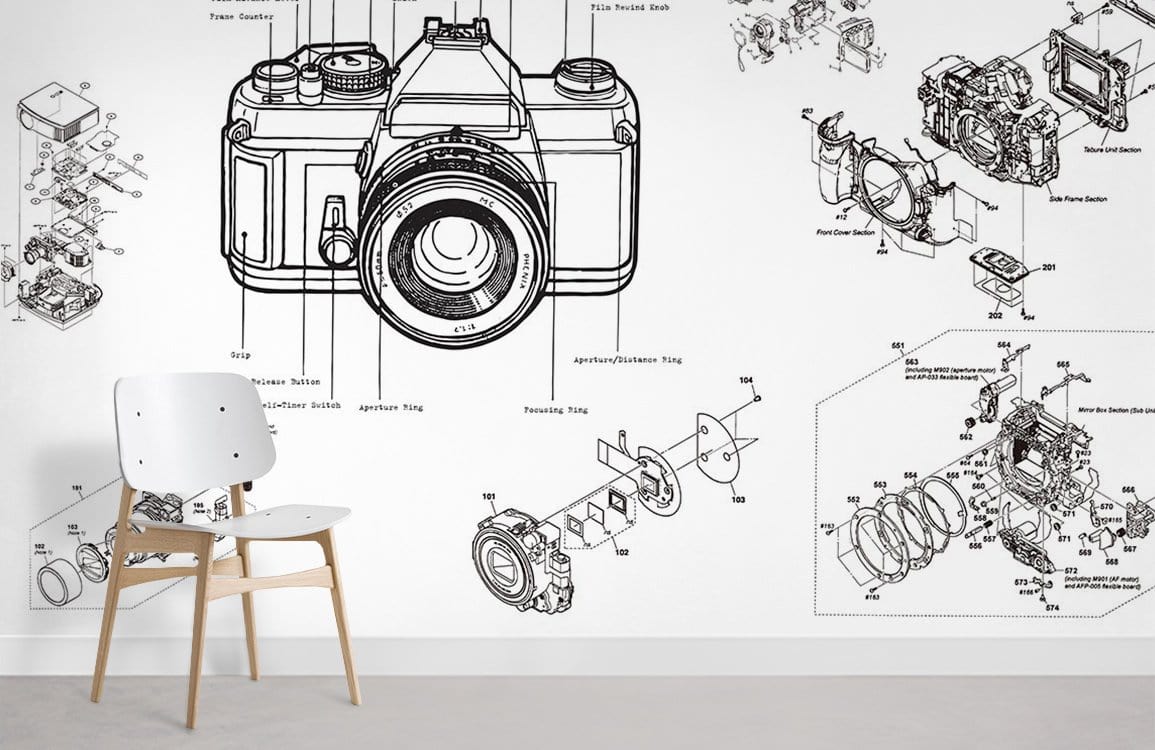 Vintage Camera Blueprint Mural Wallpaper in monochrome, featuring industrial design with white chair, grey floor.