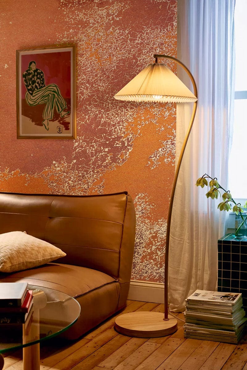 Rustic Earth Tone Abstract Mural Wallpaper, metallic accents, with leather sofa and wooden floor.