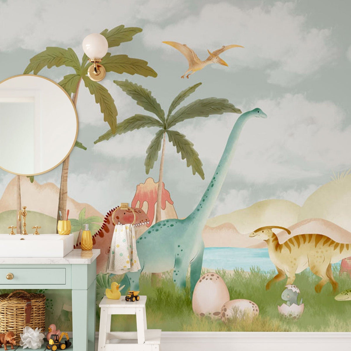 Pastel jungle dinosaur mural with mint vanity, wicker basket, and mirror in stylish bathroom setting.