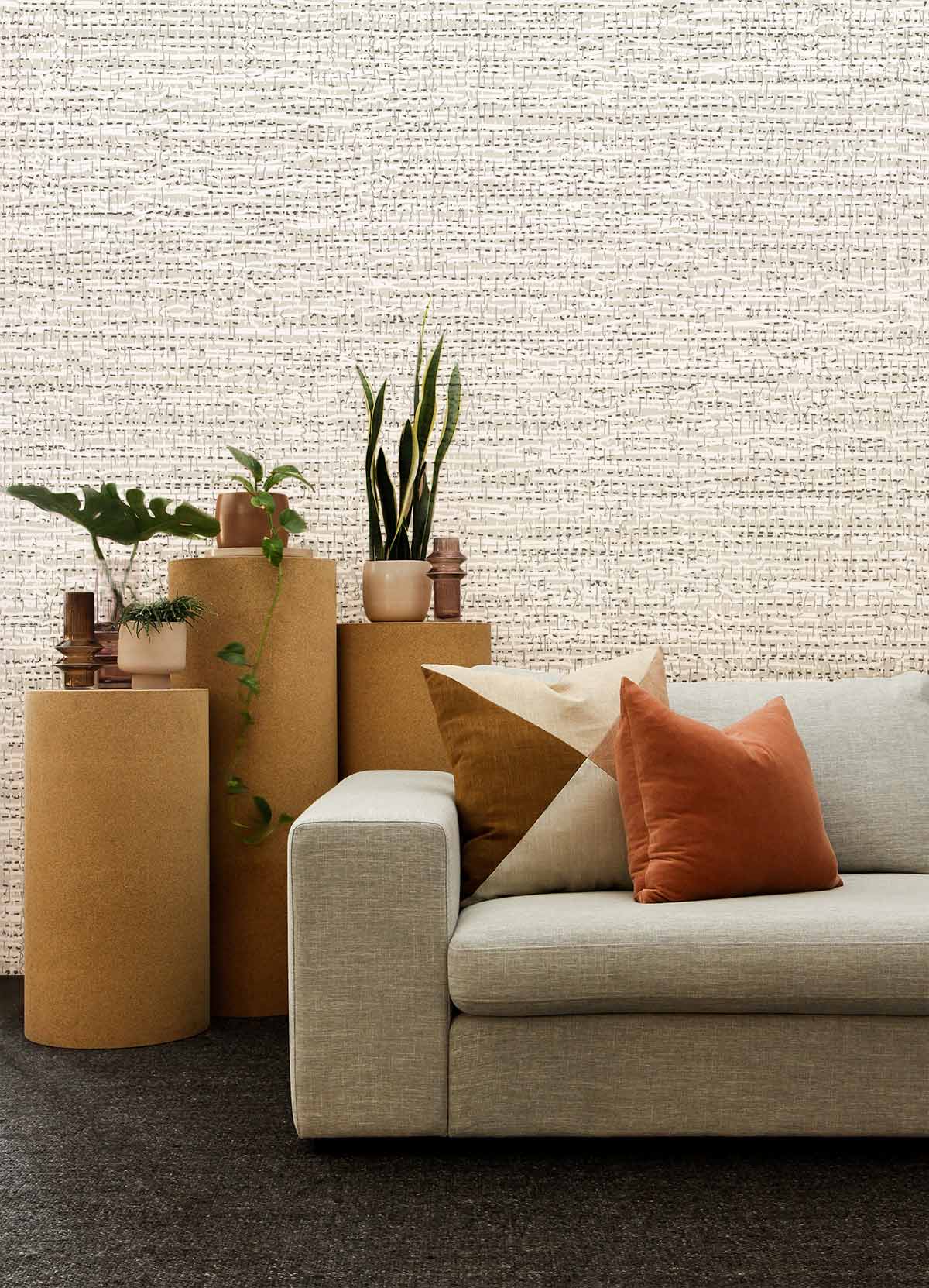 Textured beige linen-effect wallpaper, modern sofa, neutral decor, elegant interior, contemporary living room.