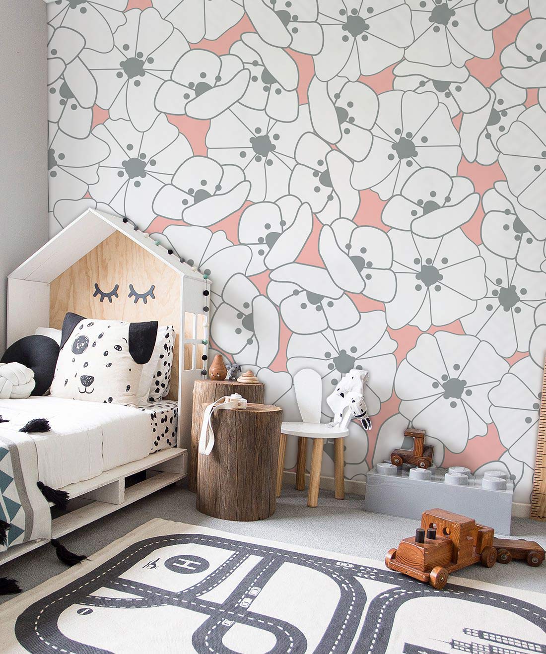 Children's room featuring contemporary floral wallpaper, soft coral, white tones, house bed, toy decor.