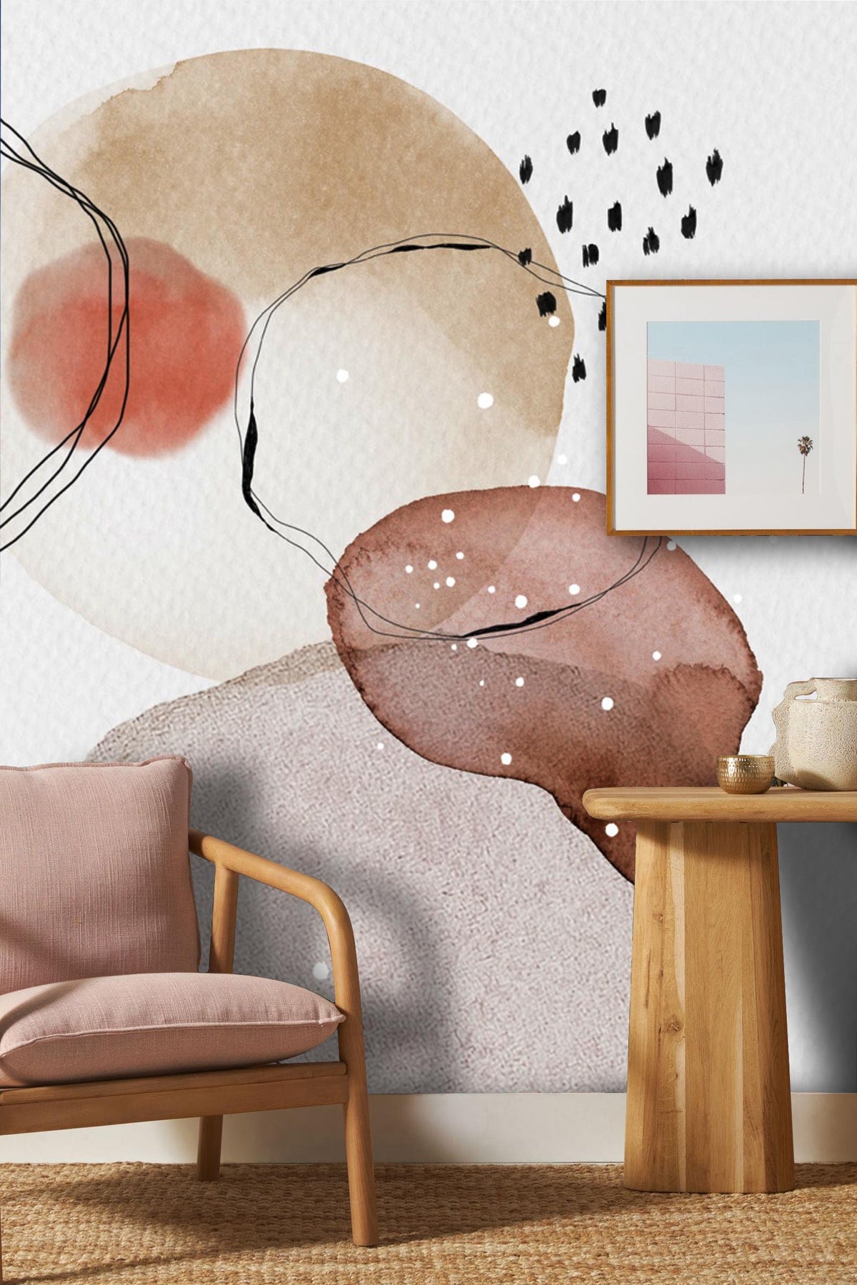 Abstract watercolour circles wallpaper, earthy tones; modern decor. Pink sofa, wooden table, artistic frame.