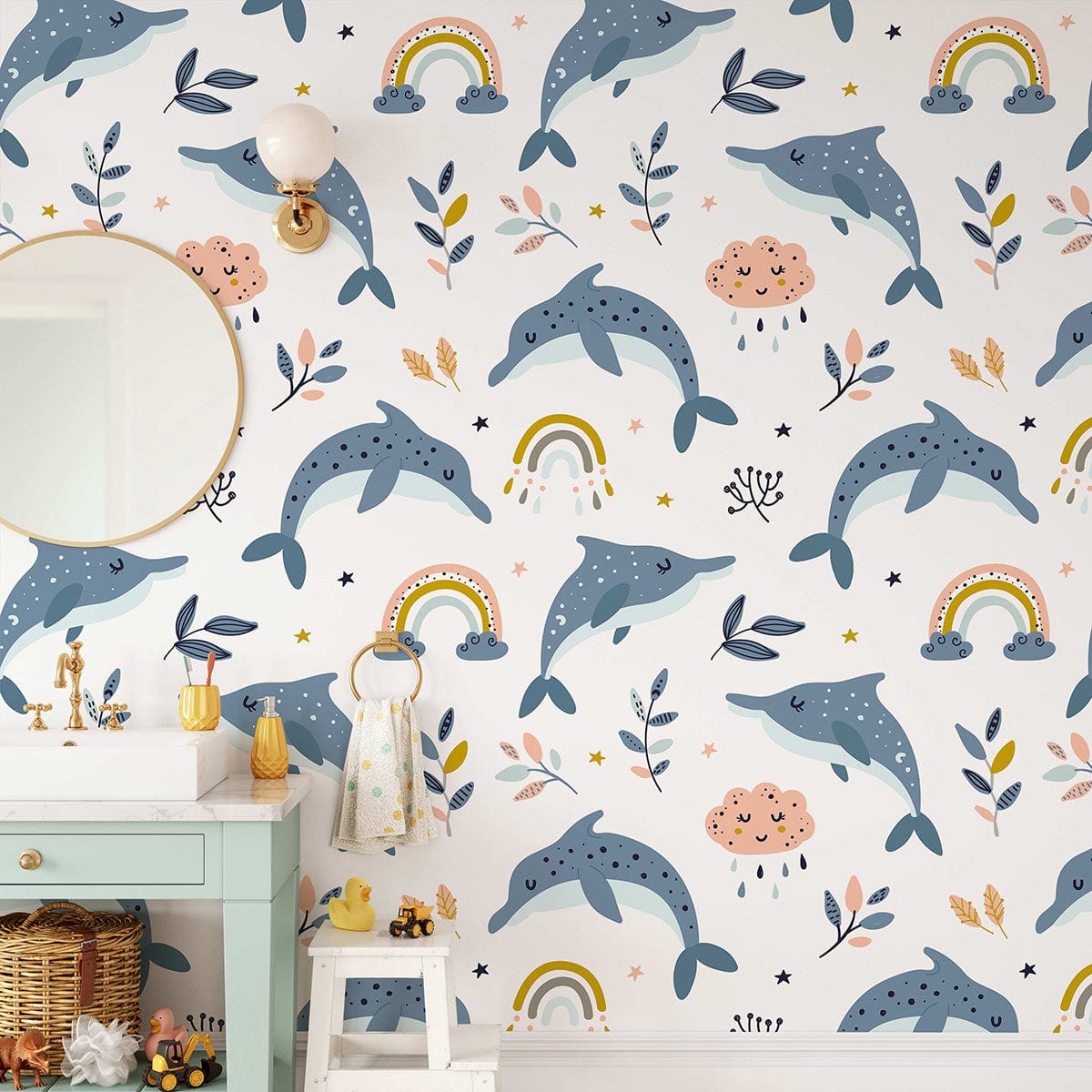 Playful nursery wallpaper with dolphins, rainbows, and clouds. Features green dresser, round mirror, basket.