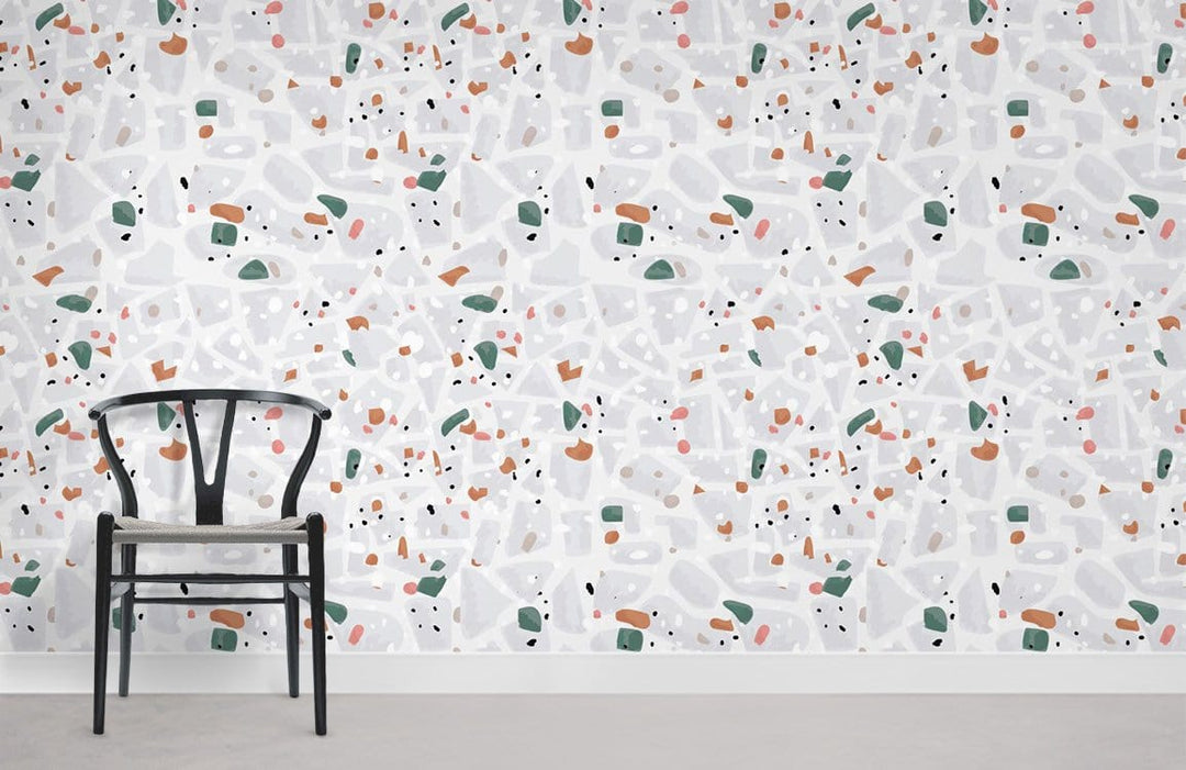 Modern Terrazzo Pattern Wallpaper in earthy tones, featuring sleek chair, complements contemporary interior decor.