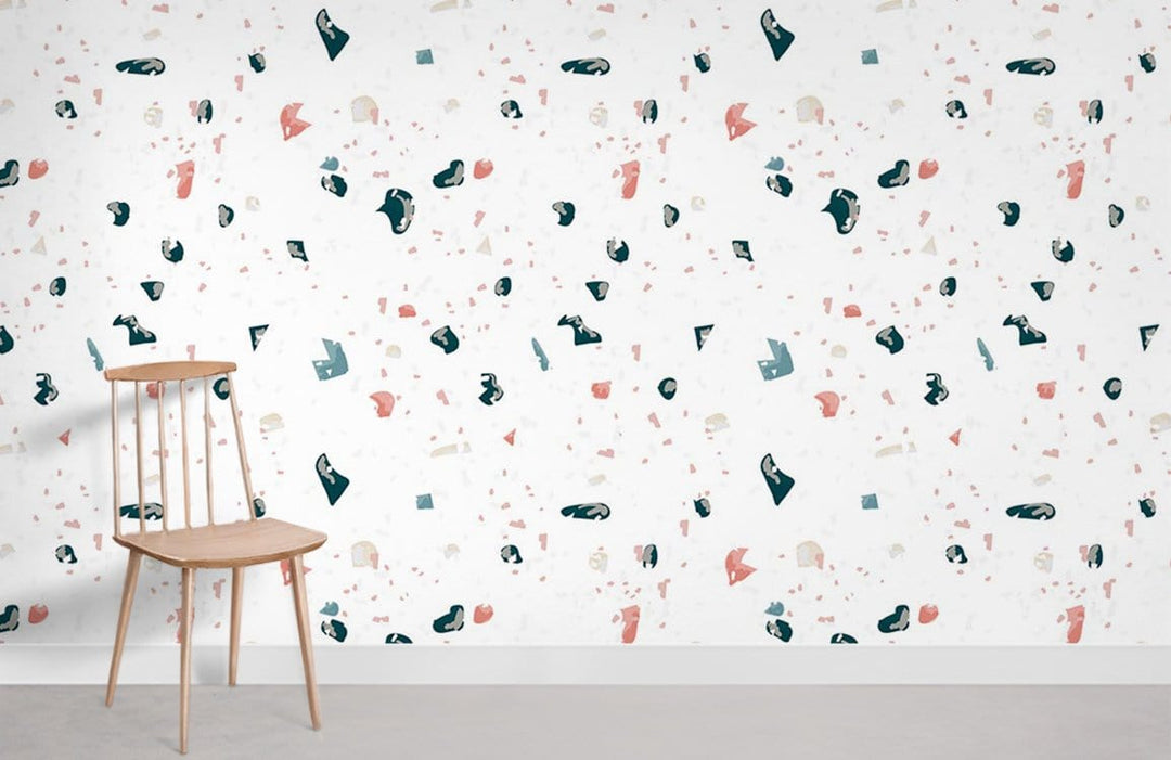 Contemporary Terrazzo Pattern Wallpaper in soft pink and teal, featuring wooden chair, light flooring.