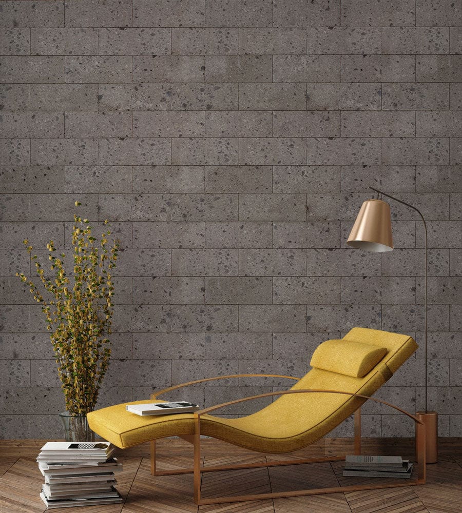 Grey brick wallpaper, yellow chaise longue, rustic flooring, industrial wall, modern living room decor.