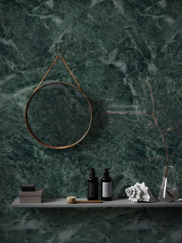Emerald green marble effect mural wallpaper with circular mirror and minimalist shelf in modern room.