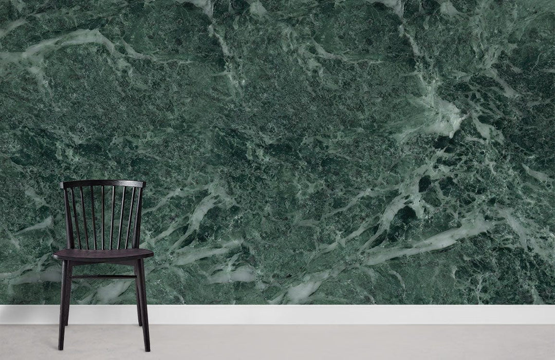 Emerald green marble effect mural wallpaper with sophisticated finish, black chair, grey flooring.