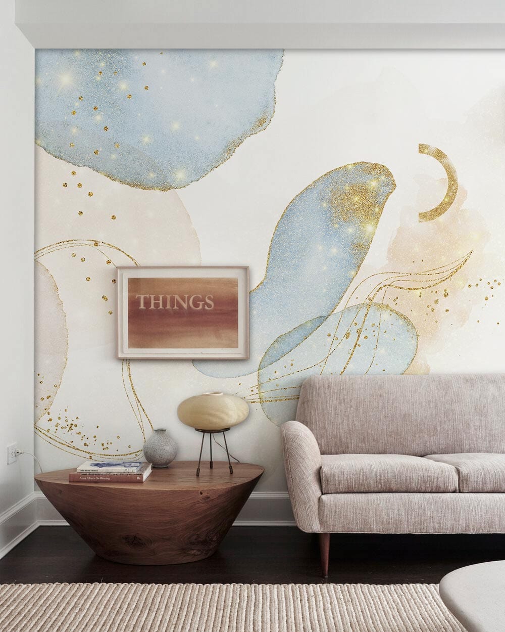 Dreamy blue and gold abstract wall mural, beige sofa, dark wood table, eclectic living room style.