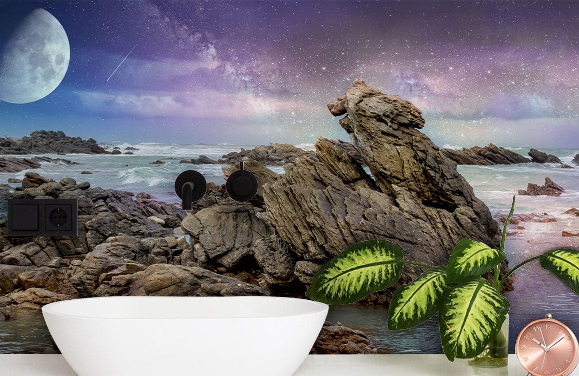 Mystical Coastal Nightscape Mural Wallpaper in bathroom with modern white basin and green plant decor.