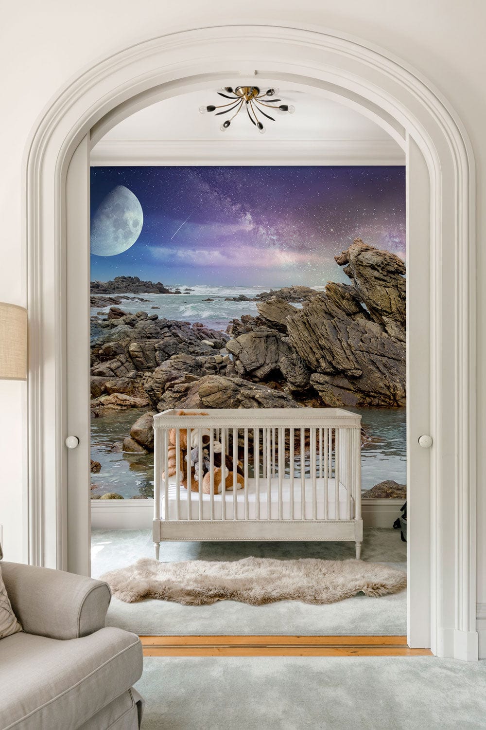 Mystical Coastal Nightscape Mural with moonlit rocks in elegant nursery featuring stylish beige sofa.