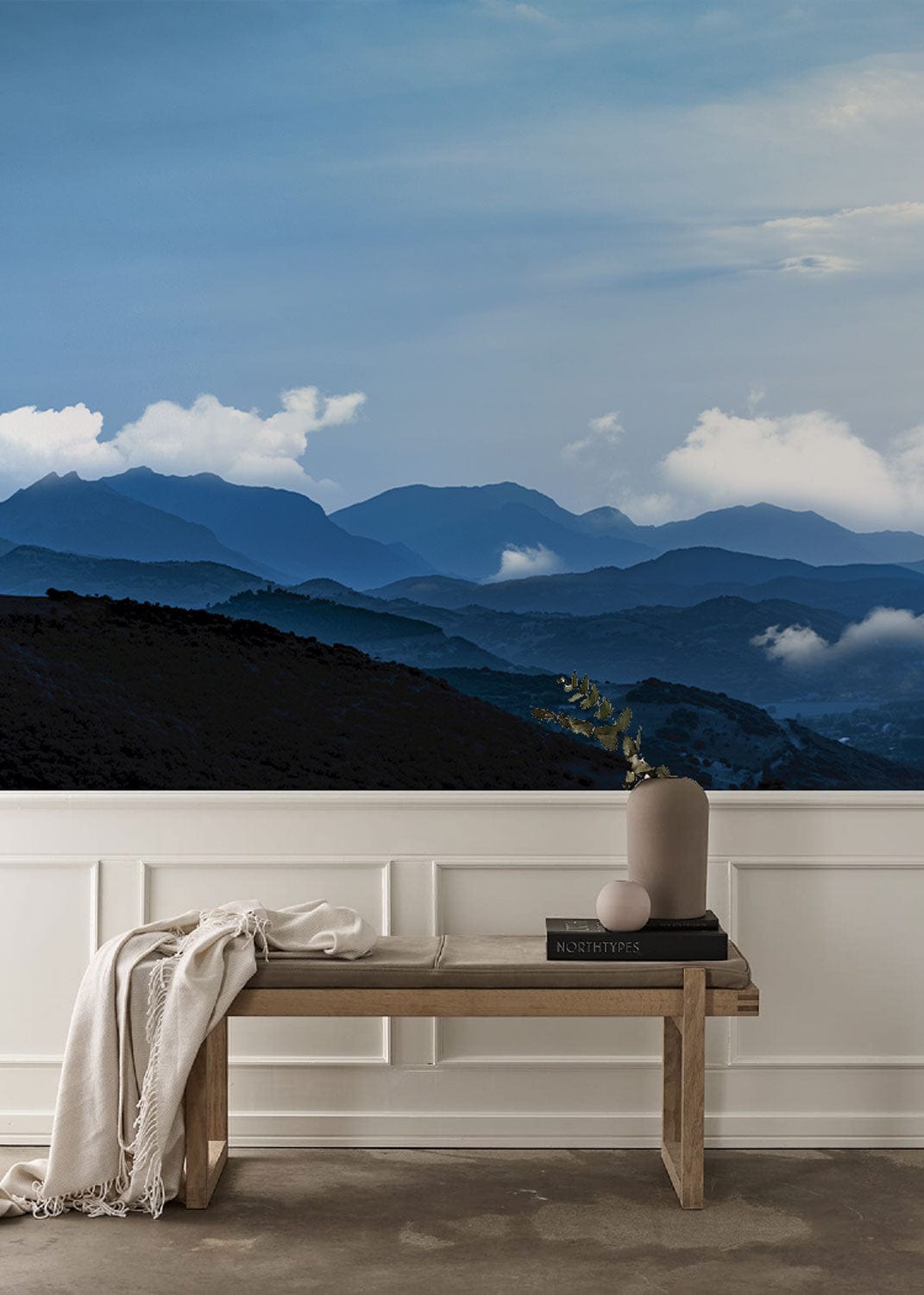 Majestic Blue Mountain Vista Scenic Mural Wallpaper in modern interior with wooden bench and panelling.