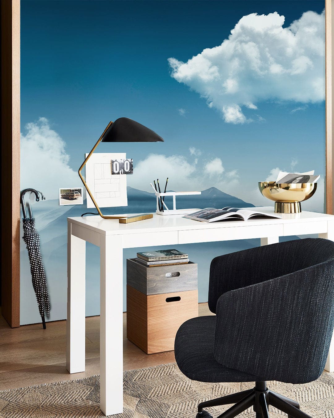 Serene Blue Mist Mountain Mural Wallpaper, clouds, desk, black chair, wood flooring, office setting.