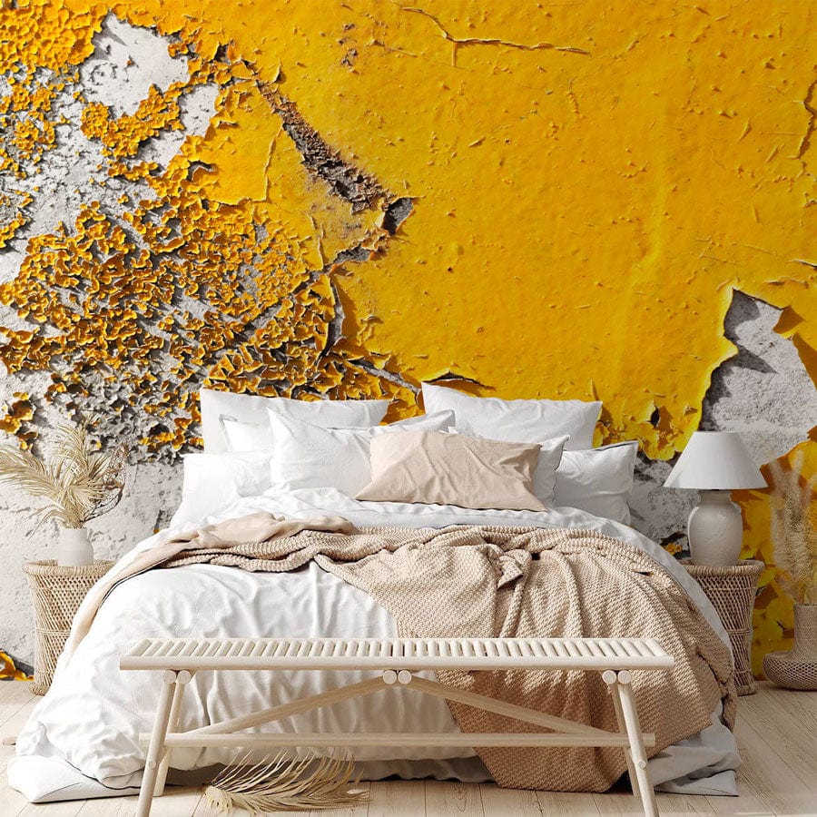 Textured Urban Decay yellow-grey mural wallpaper, cosy bedroom design with white bedding, wicker bench.