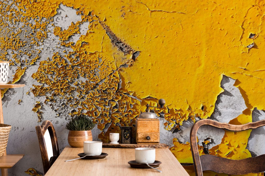 Textured Urban Decay yellow-grey abstract mural wallpaper in dining room with rustic wooden furniture.